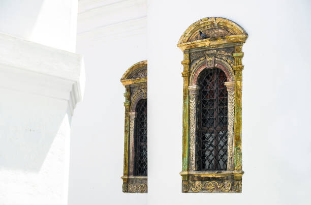 istock Stone windows on a white background of orthodox monastery church 916885624