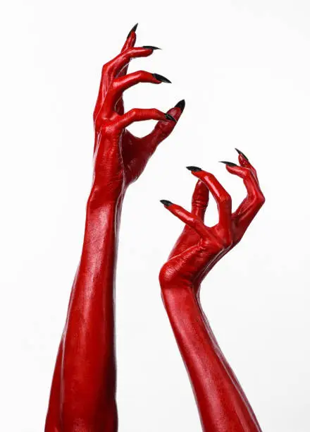 Red Devil's hands, red hands of Satan, Halloween theme, white background, isolated