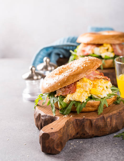istock Bagels with scrambled eggs, rucola and fried bacon 916889194