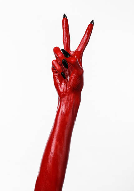 istock Red Devil's hands, red hands of Satan, Halloween theme, white background, isolated 916889250