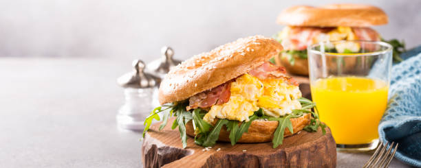 istock Bagels with scrambled eggs, rucola and fried bacon 916889720