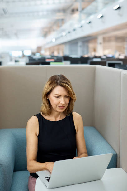 istock Mature businesswoman using laptop in office 916890392