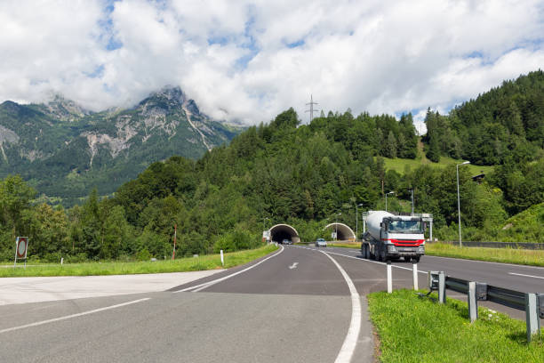 istock Austrian highway with cars leaving a tunnel through a mountain 916892390