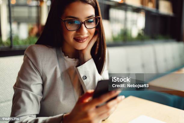 Pretty Businesswoman Holding A Mobile Phone Stock Photo - Download Image Now - Women, One Woman Only, Mobile Phone