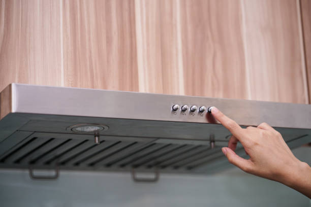 istock caucasian women hand using the range hood in modern kitchen 916896542