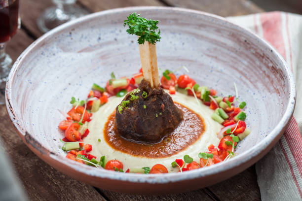 Baked lamb shank with eggpland puree, hunkar begendi Baked lamb shank with eggpland puree, hunkar begendi or sultan's choice traditional turkish dish hunkar begendi stock pictures, royalty-free photos & images