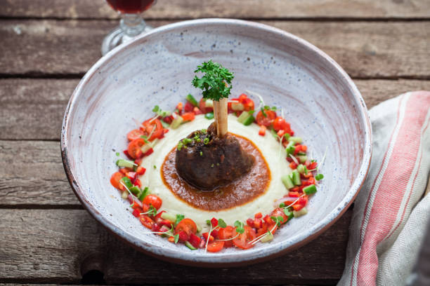 Baked lamb shank with eggpland puree, hunkar begendi Baked lamb shank with eggpland puree, hunkar begendi or sultan's choice traditional turkish dish hunkar begendi stock pictures, royalty-free photos & images