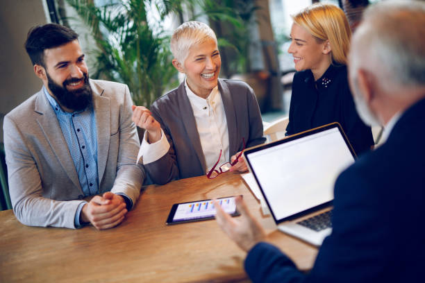 istock Mixed age business team is having a meeting in a cafe 916901042