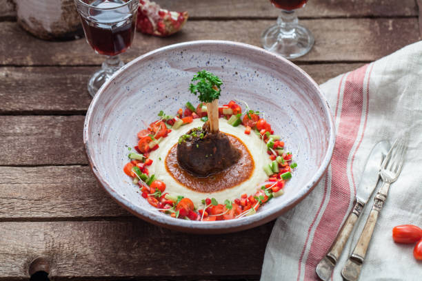 Baked lamb shank with eggpland puree, hunkar begendi Baked lamb shank with eggpland puree, hunkar begendi or sultan's choice traditional turkish dish hunkar begendi stock pictures, royalty-free photos & images