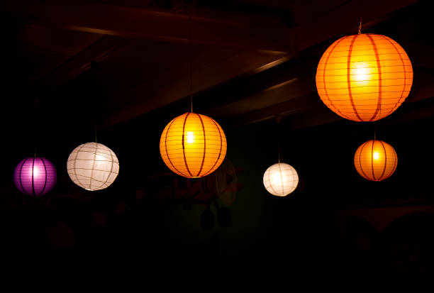 Image of five colorful paper lampion balls on a dark background