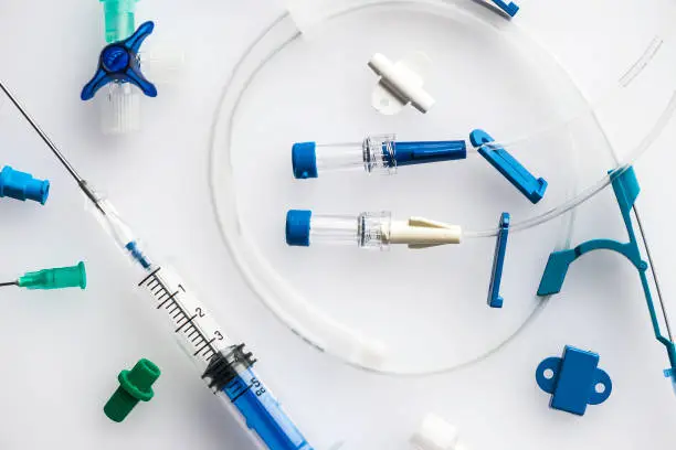 Photo of Syringe with needle and plastic tubes for central venous catheter insertion