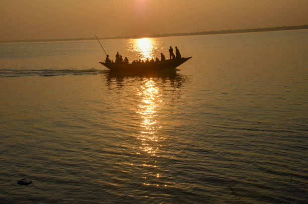 istock Boat full of passengers on river Ganges at sunset. 916907620