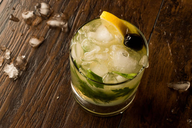 istock Dillionaire Cocktail with Dill, Gin, Parsley, lemon, Olive and Crushed Ice. 916908014