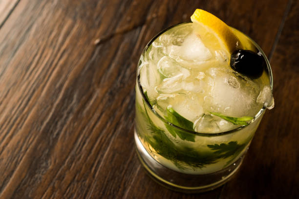 istock Dillionaire Cocktail with Dill, Gin, Parsley, lemon, Olive and Crushed Ice. 916908074