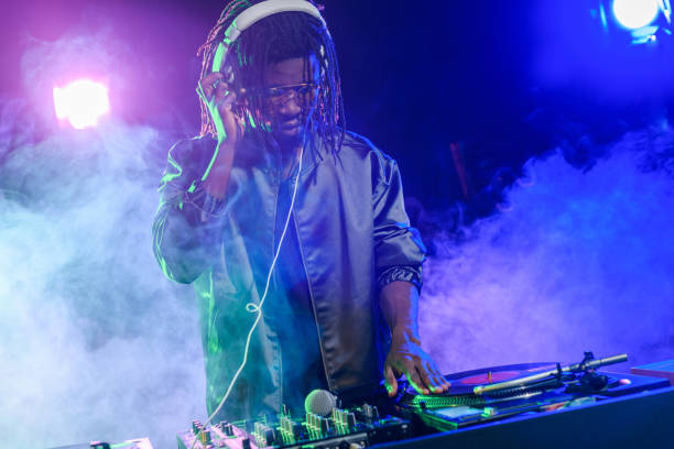 istock DJ in headphones with sound mixer 916908220