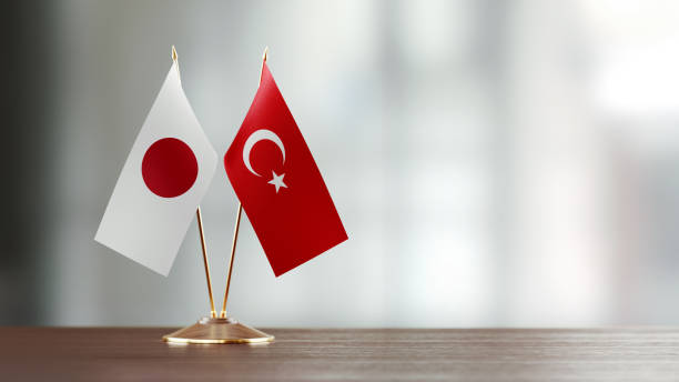 istock Japanese And Turkish Flag Pair On A Desk Over Defocused Background 916910770