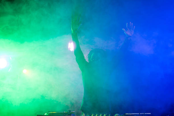 istock DJ in nightclub with back light 916913440