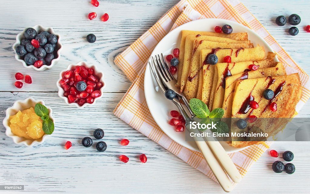 Sweet pancakes on milk with honey and fresh berries Sweet pancakes on milk with honey and fresh berries, healthy breakfast concept Crêpe - Pancake Stock Photo