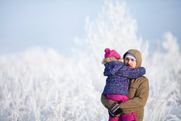 istock Father and daughter at snowy park. 916913808