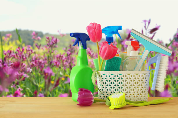 istock Spring cleaning concept with supplies on wooden table. 916914534