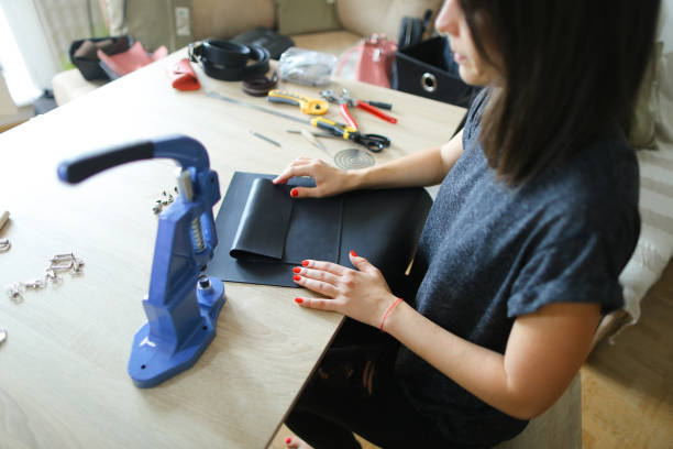 istock girl preparing leather for making purse 916921820