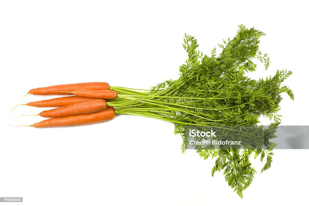 Bunch of carrots with stems on white background Fresh and ripe bunch of orange carrots isolated on white background. Carrot Stock Photo