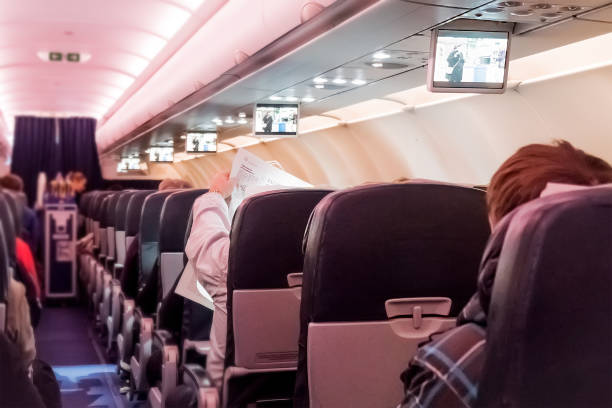 istock Interior of large passengers airplane with people on seats. 916925790
