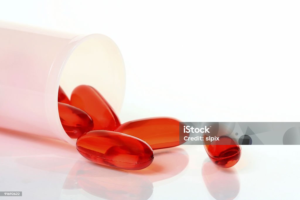 Arancione trasparente capsule a flacone di pillole - Foto stock royalty-free di Acido acetilsalicilico