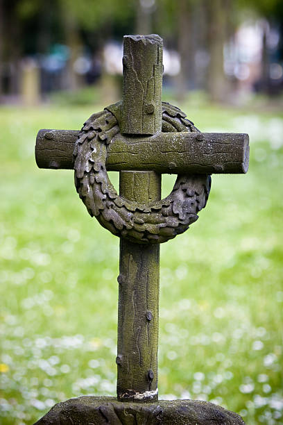 Grave Yard Cross with Garland stock photo