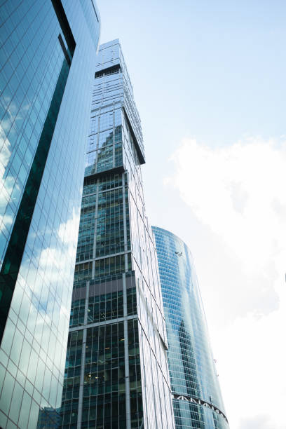 istock Detail blue glass building background with cloud sky 916935328
