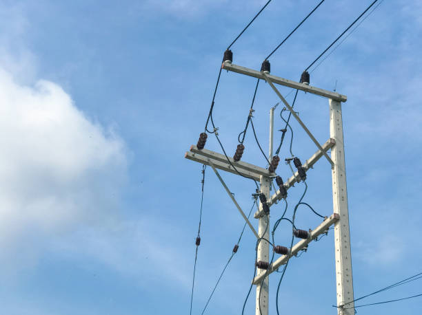 istock Electricity poles high power system and wires with blue sky 916940854