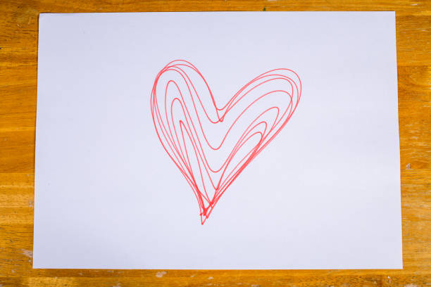istock Heart drawn by pen on paper sheet, Valentine's day concept 916941282