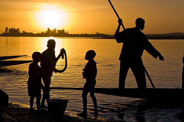 Silhouette of fisherman on Niger river  mali stock pictures, royalty-free photos & images