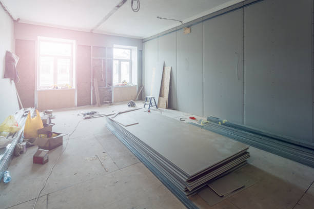 istock Working process of installing metal frames for plasterboard (drywall) for making gypsum walls  in apartment is under construction, remodeling, renovation, extension, restoration and reconstruction. 916945092