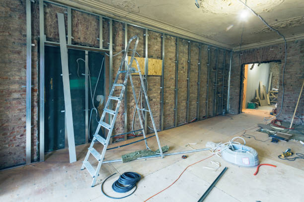 istock Working process of installing metal frames for plasterboard (drywall) for making gypsum walls with ladder and tools in apartment is under construction, remodeling, renovation, extension, restoration and reconstruction 916945094
