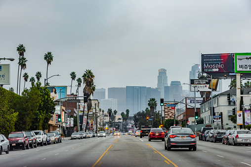Los Angeles, California,USA - February 10, 2018 : Korea Town street in Los Angeles  California. Los Angeles has the most korean population in USA and known for its ethnic food and culture . Downtown Los Angeles skyscrapers can be seen in the background.