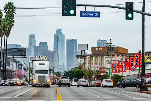 Los Angeles, California,USA - February 10, 2018 : Korea Town street in Los Angeles  California. Los Angeles has the most korean population in USA and known for its ethnic food and culture . Downtown Los Angeles skyscrapers can be seen in the background.