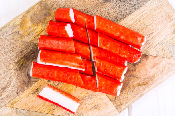 istock Crab sticks untreated on wooden cutting board 916954342