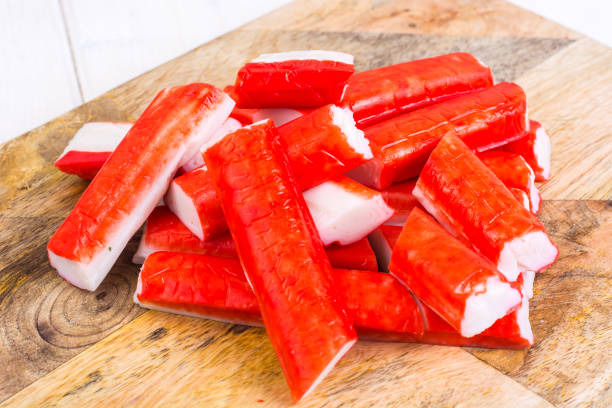 istock Crab sticks untreated on wooden cutting board 916954350
