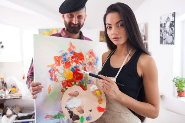 istock Artists presenting flowers painting 916959086