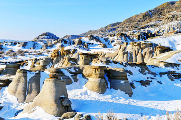 Rock hoodoos near Drumheller, Alberta,Canada Winter landscape with snow and beautiful hoodoo rock formations in the Drumheller Valley. drumheller stock pictures, royalty-free photos & images