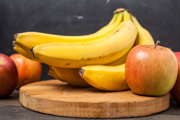 istock banana and apple on chopping 916966508