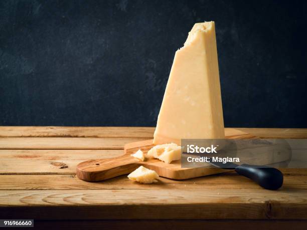 Parmesan Cheese On Wooden Table Stock Photo - Download Image Now - Parmesan Cheese, Cheese, Aging Process