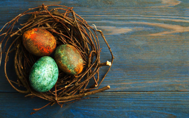 istock Easter eggs on a wooden background .Easter eggs of different colors .Easter eggs top view 916966822