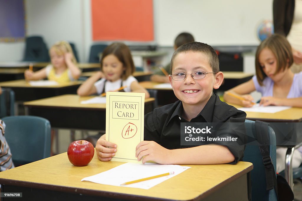 Child at school with report card  Report Card Stock Photo