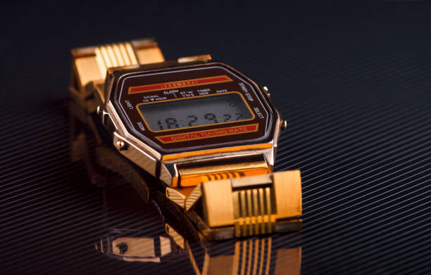istock old-fashioned electronic wristwatch on black background. Toned 916973038