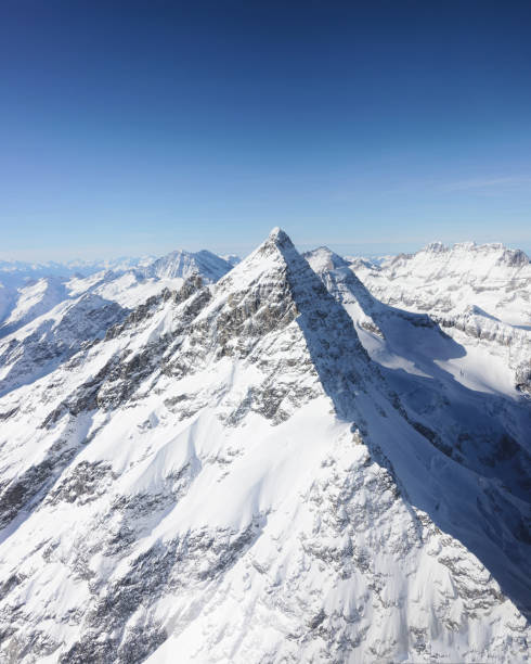 Jungfrau Mountain peak in winter Swiss Alps Jungfrau Mountain peak in winter Swiss Alps, helicopter view thun interlaken winter switzerland stock pictures, royalty-free photos & images