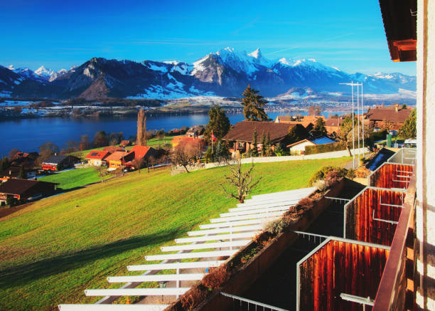 Balcony in Sigrilwil village at Swiss Alps mountains Thun lake View from balcony on Sigrilwil village at Swiss Alps mountains and Thun lake, Switzerland in winter thun interlaken winter switzerland stock pictures, royalty-free photos & images