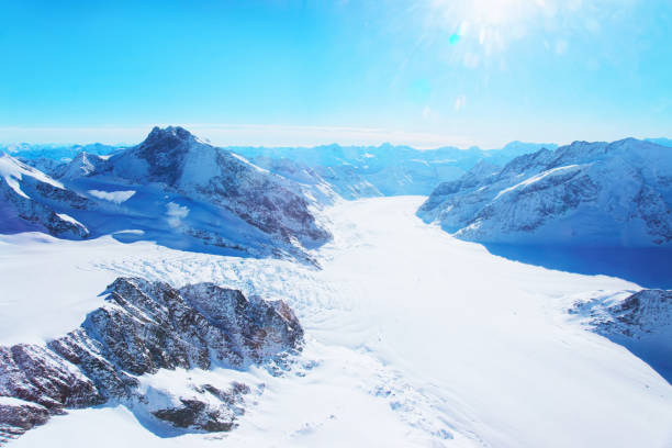 Mountain peaks ridge with Aletsch glacier in winter Swiss Alps Mountain peaks ridge with Aletsch glacier in winter Swiss Alps helicopter view thun interlaken winter switzerland stock pictures, royalty-free photos & images