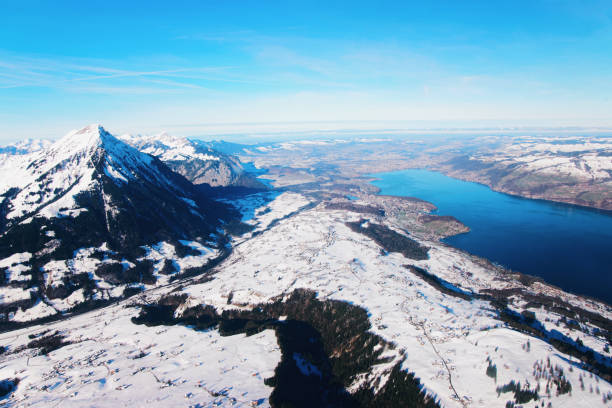 Mountain Niesen peak and Thun Lake Mountain Niesen peak and Thun Lake at helicopter view thun interlaken winter switzerland stock pictures, royalty-free photos & images